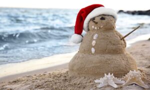 snowman made of sand on beach