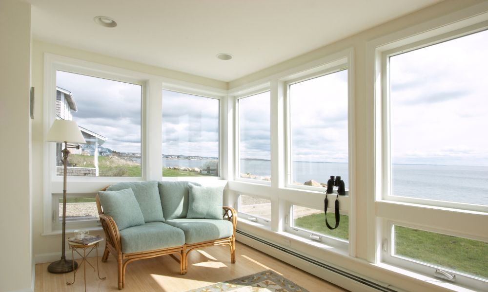 room with large windows overlooking beach