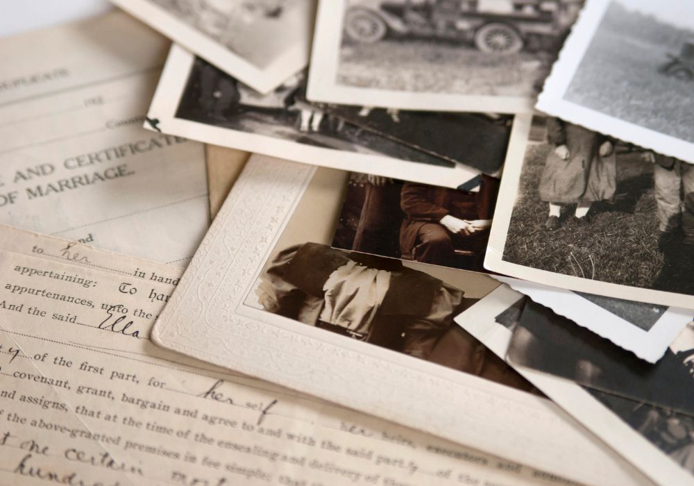 Historical black and white photos over a hand-written document