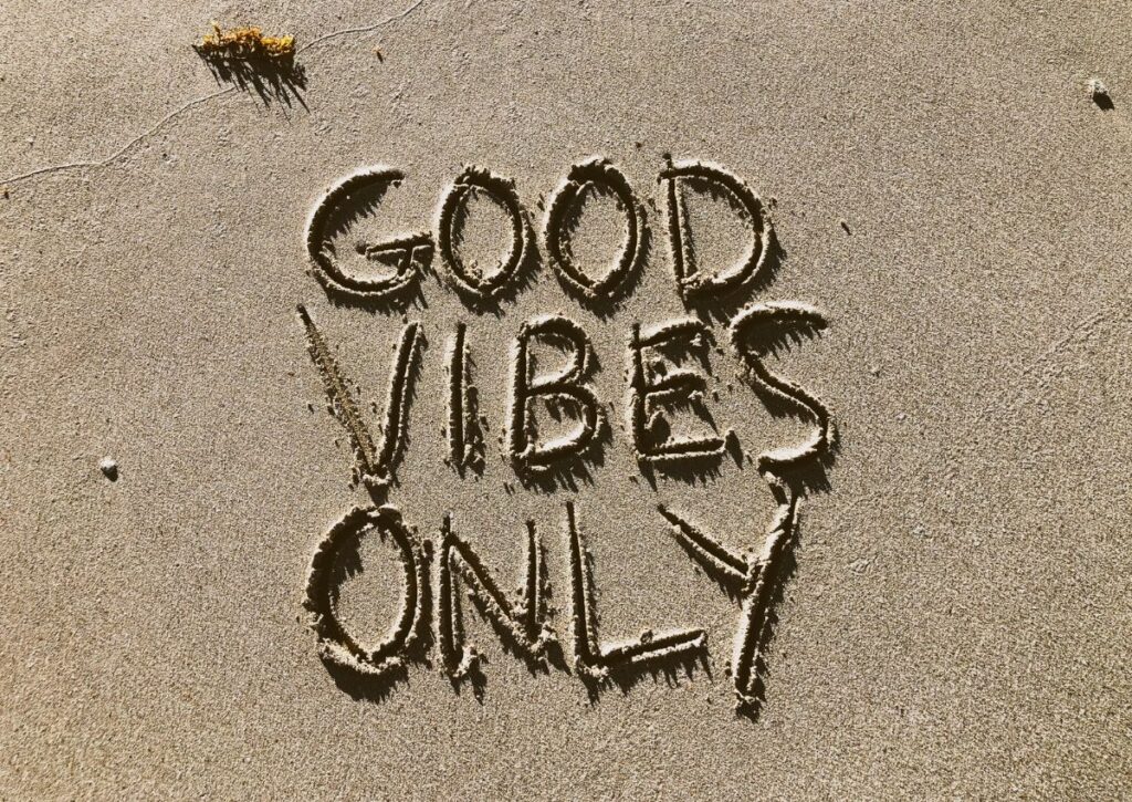 Good Vibes Only written in sand