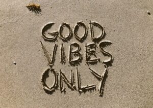 Good Vibes Only written in sand