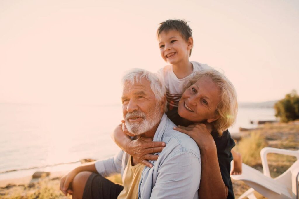 Grandparents playing with their grandson on Hilton Head beach.